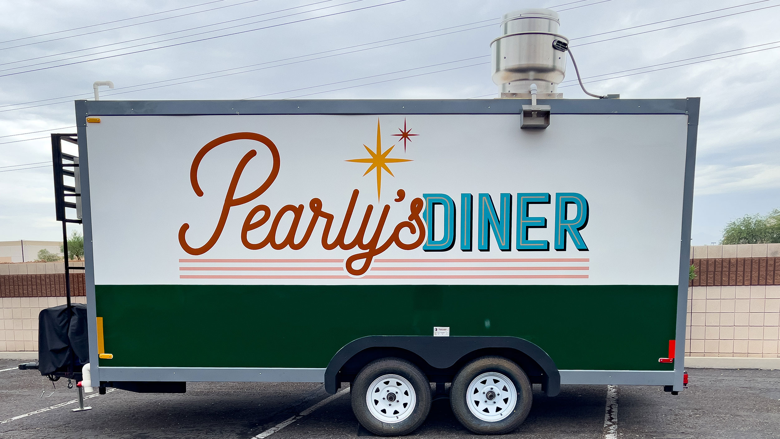 Food trailer with a custom spot graphic on the side
